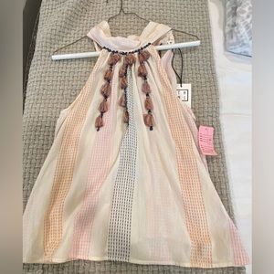 Boutique tank top. New with tags never worn. Tassels on front tie in back.